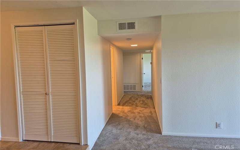 Hallway leading to bedrooms/baths. Laundry closet to the left.