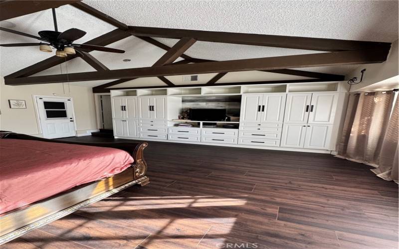 This updated farm house has wooden beams in the master bedroom. The beams add a rustic charm to the room.