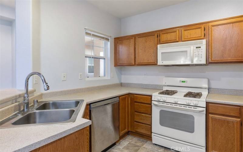 Warm wood cabinetry, modern appliances, and ample counter space to inspire your culinary creations.