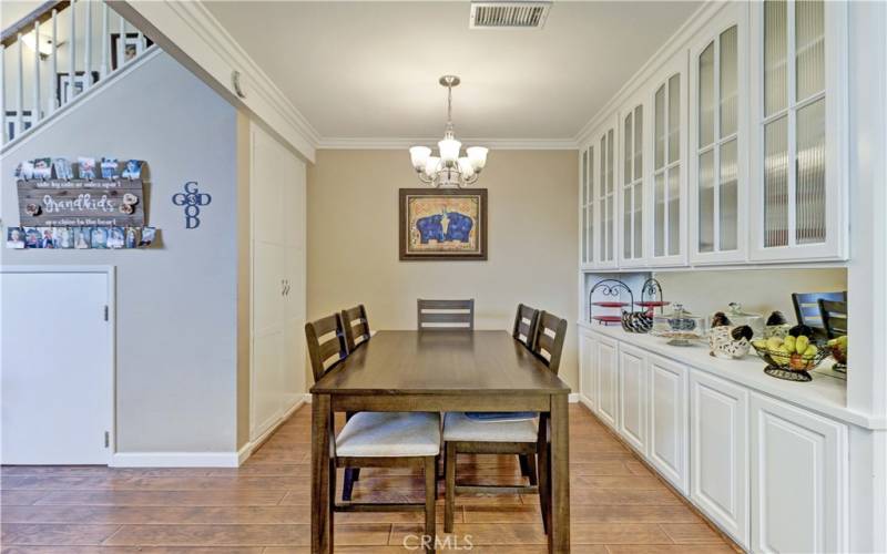 DINING AREA & STORAGE CABINET UNDER THE STAIRCASE ON LEFT