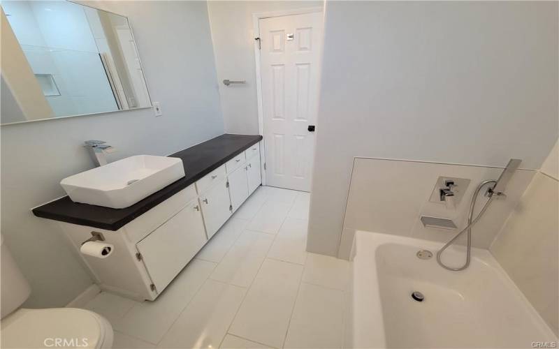 Bathroom with a tub and shower