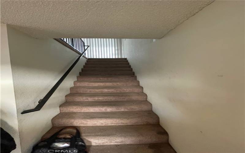 Staircase going up to top floor living area.