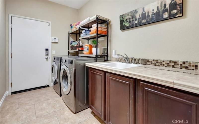 Laundry room with sink and folding counter.