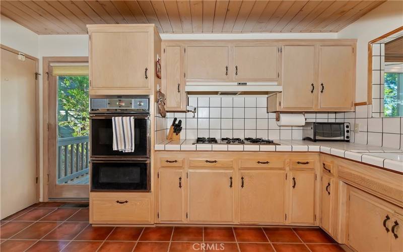 Kitchen With Main Deck Access And Door To Lower Level Stairs