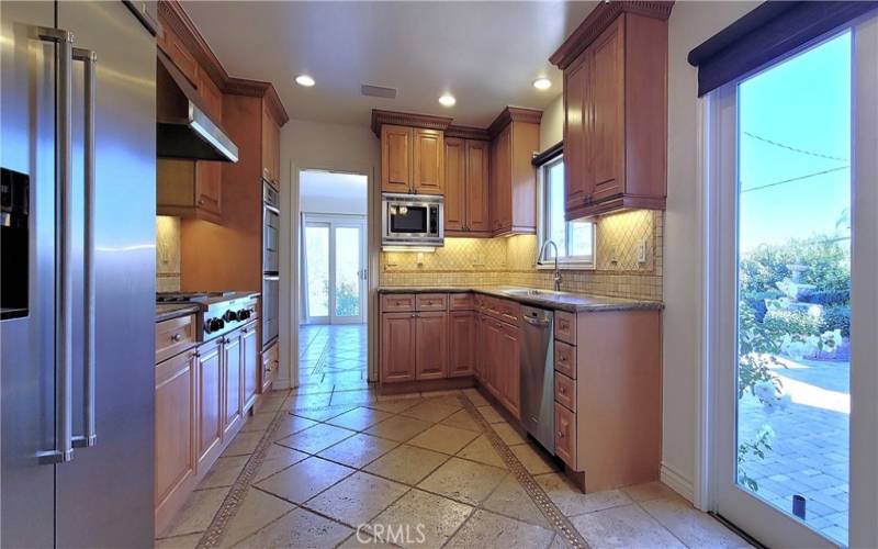 Kitchen with a door to BBQ area and rooftop deck