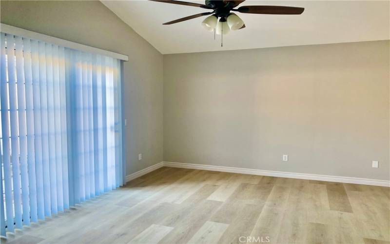 Spacious Primary bedroom with sliding glass door and view of the pool.