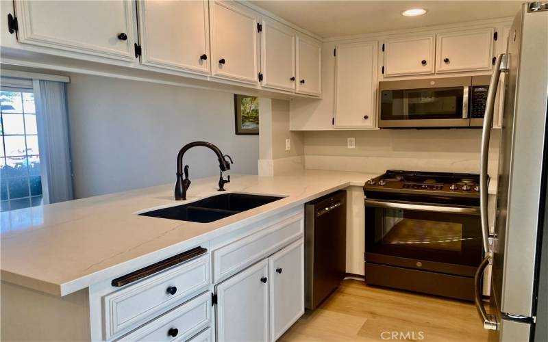 Quartz countertop with Stainless steel appliances.