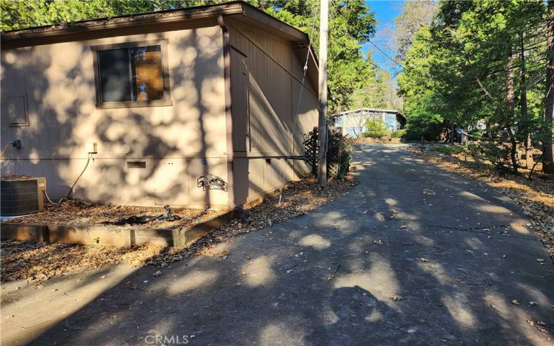 Concrete driveway to garage and carport in back