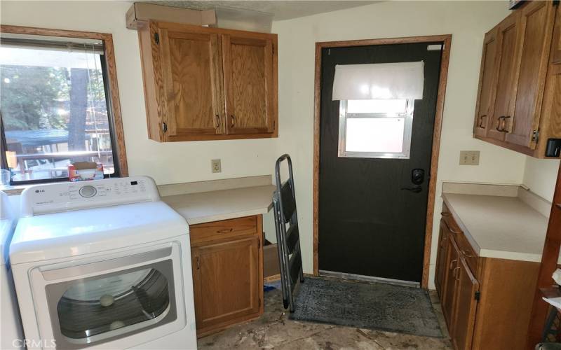 Laundry room with counters and cabinets