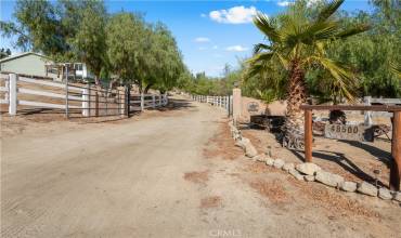 Entry to the estate with an electric gate. Showing off the beautiful driveway to the homes.