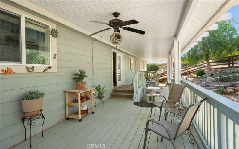 Rear deck of the main home. There is a fountain and the concrete benches and table stay with property.