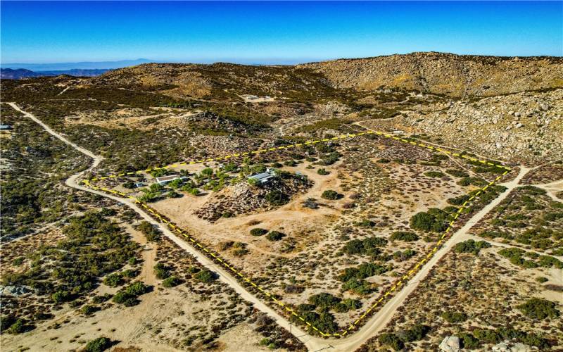 Drone shot of the estate. It's fenced on three sides.