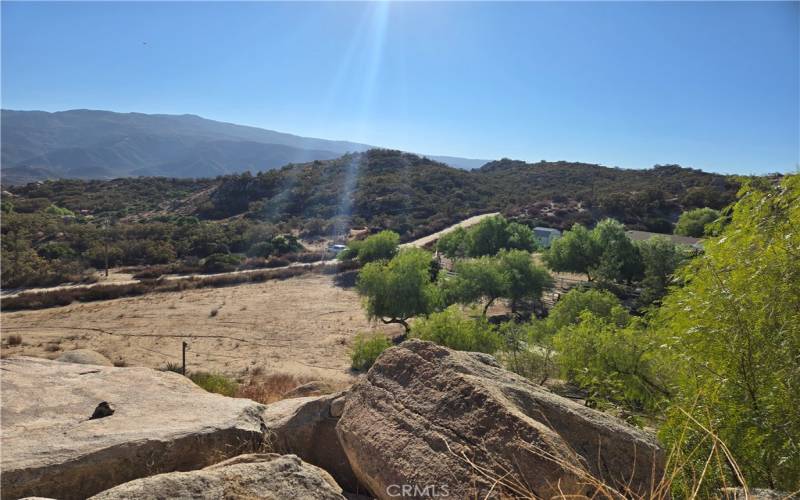 View from 2nd home, looking down a portion of the property. The rocks are awesome! In fact, this entire estate is awesome! One of a kind and very unique!