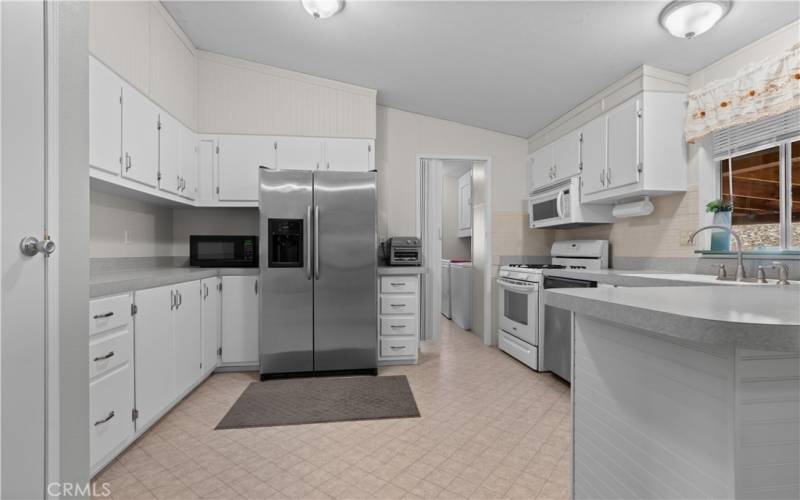 2nd home kitchen with a large pantry, door on the left of pic. Leads into the laundry room.