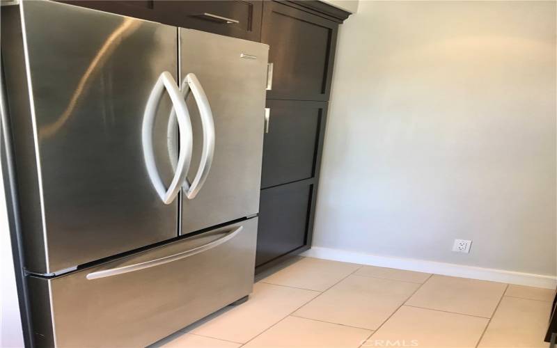 Stainless steel refrigerator and pantry area.