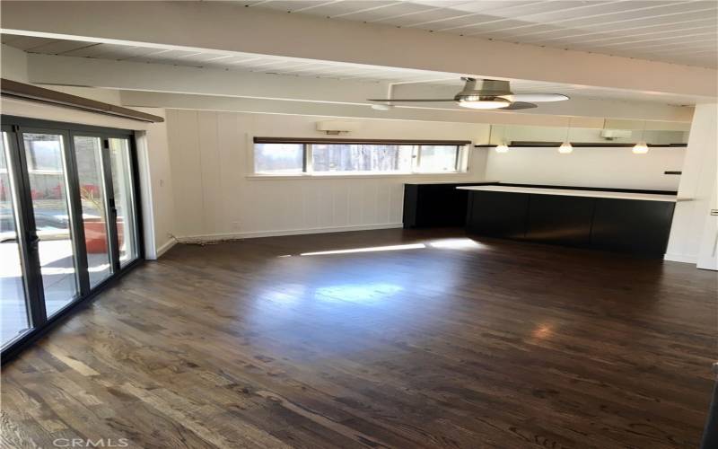 Family room ready for entertainment; a bar and wall of La Cantina doors out to the pool/spa