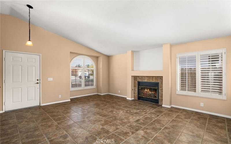 Living room with fireplace and shutters