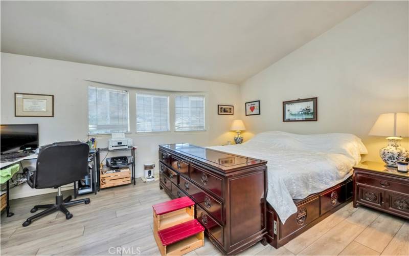 Primary bedroom with bow window.