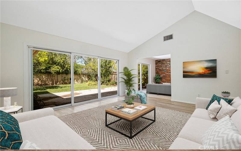 High ceilings living room with view of back yard