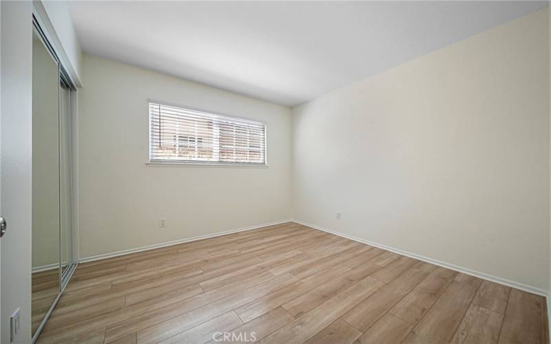 Master bedroom with two mirror closet doors