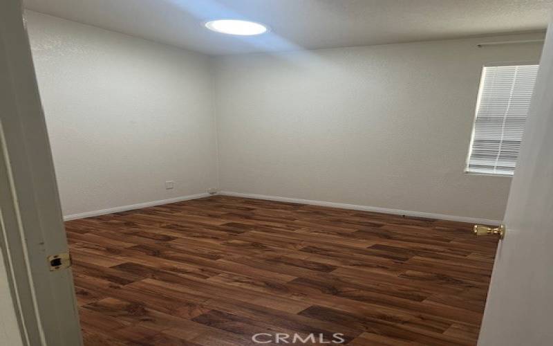 Guest Bedroom 2 with Solar Tube Lighting, Vinyl Plank Flooring and a large walk in closet