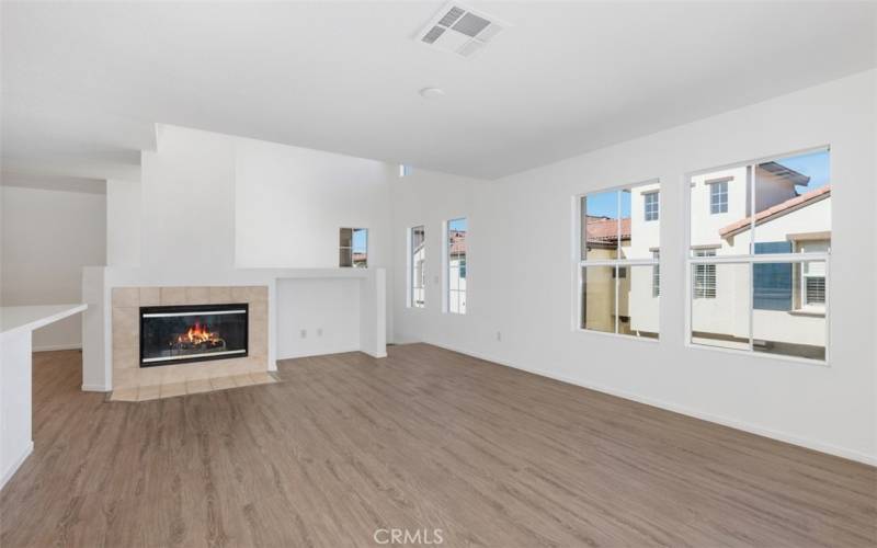 From the Entry Up the Stairs to the Living Room Featuring a Gas Fireplace