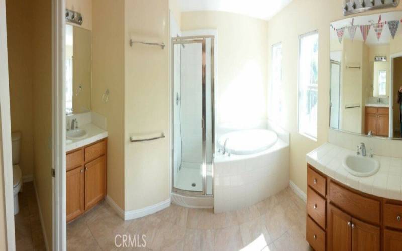 Primary bathroom with showe and oversize tub and dual sinks