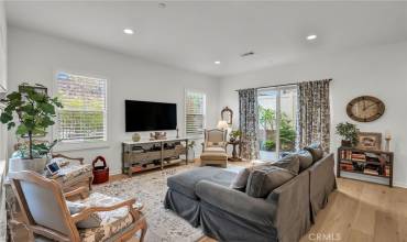 Living room with lots of natural light and slider leading to backyard