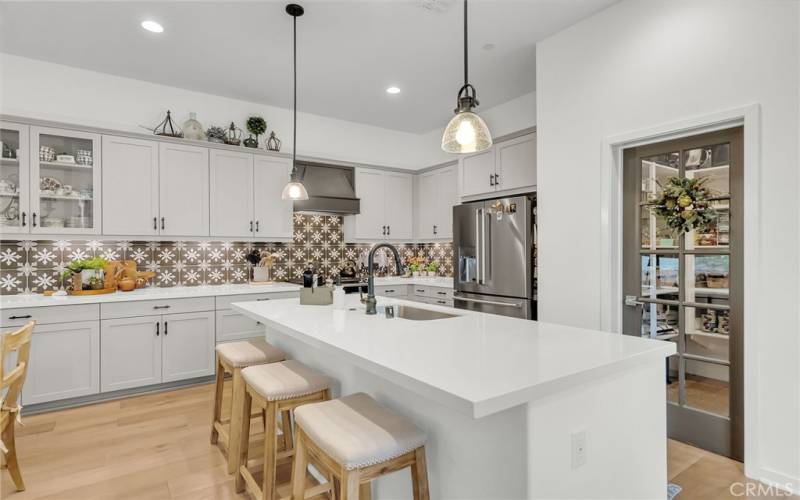 custom hood above the stovetop and custom backsplash