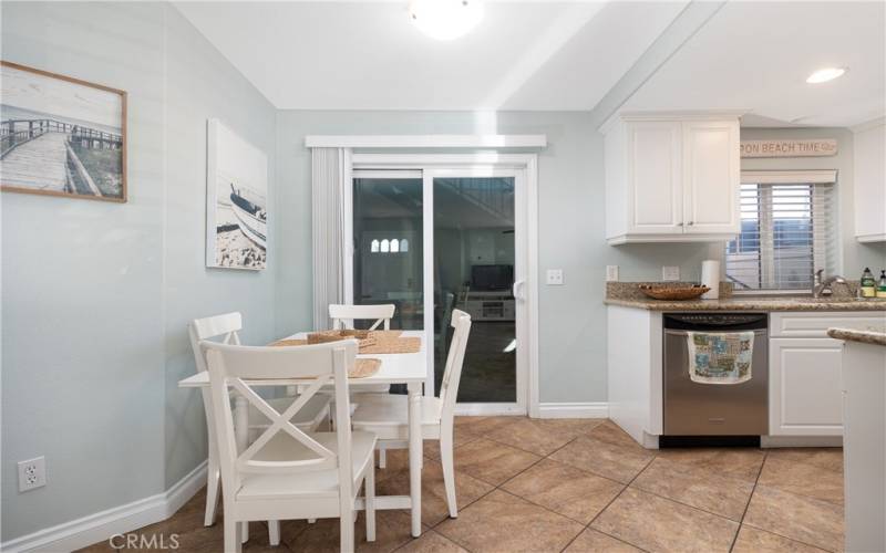 Dining nook, with back slider to the back of the property & the garage