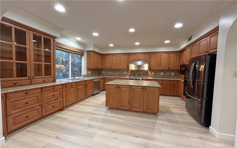 Kitchen with Viking 6 burner stove, ovens, microwave, French door refrigerator, and dishwasher.