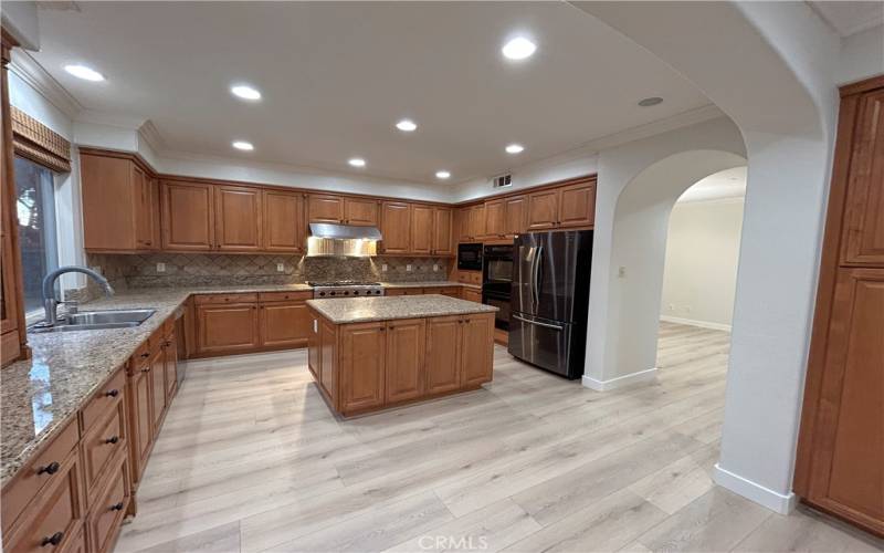 Kitchen with Viking 6 burner stove, ovens, microwave, French door refrigerator, and dishwasher.