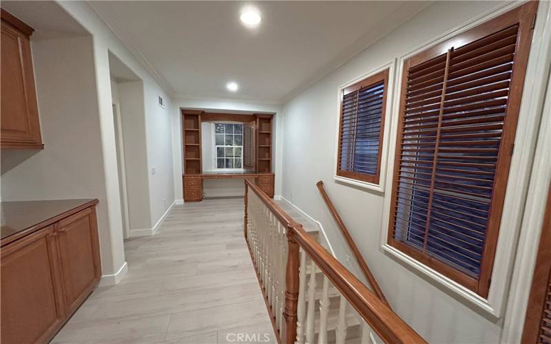 Second floor hallway and built in cabinet and study desk.