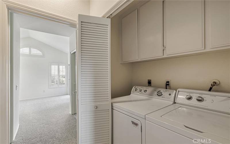 In door Laundry with Washer and dryer in Hall with storage