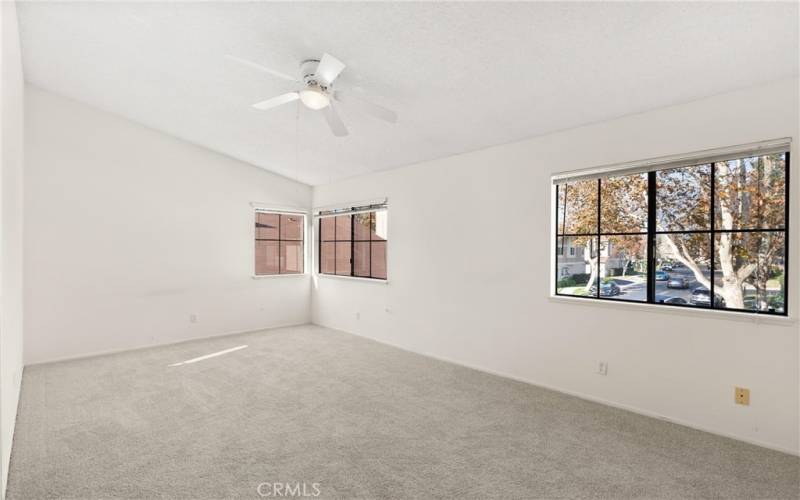 Primary bedroom with vaulted ceilings.