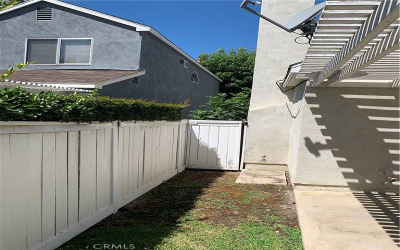 View to gate in front of south side yard. Side yard has very ample storage area. Avoid all storage fees.