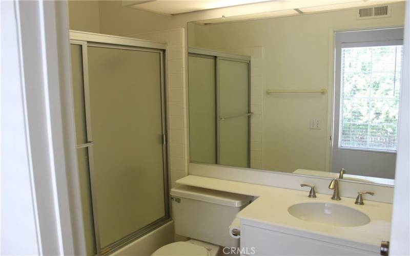 Upstairs hallway bathroom with full tub and shower