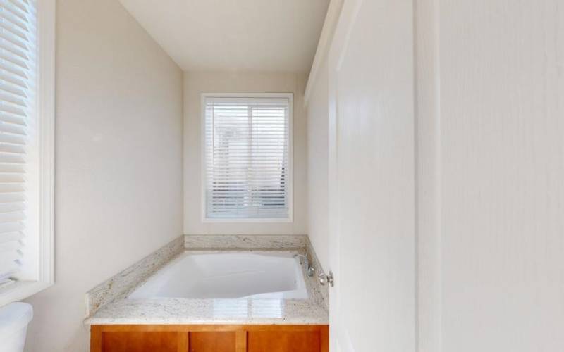 Soaking tub in primary room