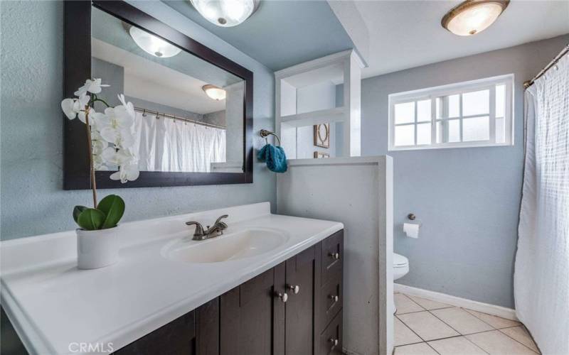 Bright and Updated Full Bath in Hall with Tile Flooring and Linen Closet (not shown in photo)