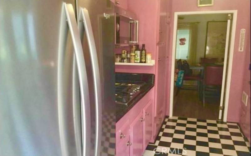 1950's era themed kitchen w/checkered floor & mod pink cabinets