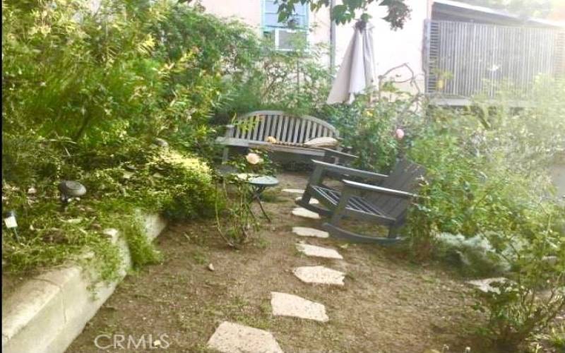 Relax in the quaint garden behind the back porch. Seats 4 people. Typically only used by residents in #15 & #14.