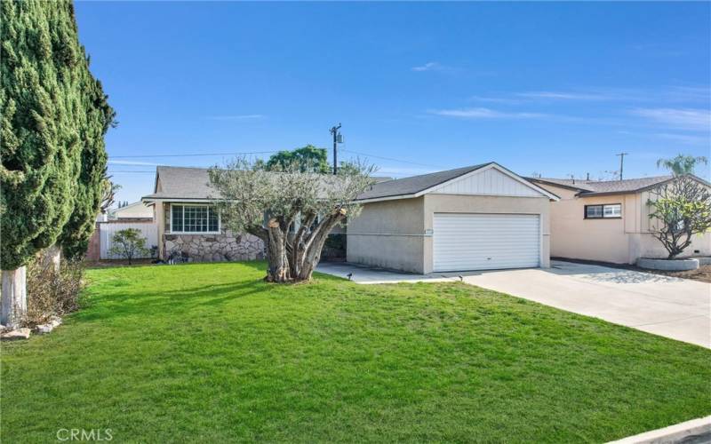 This home has a large front yard and long driveway.