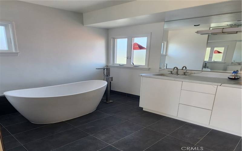 Newly remodeled, spacious primary bath with double sinks and large walk-in shower with dual shower heads