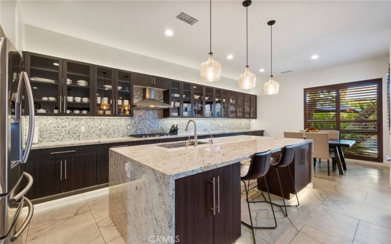 Large kitchen island including stools.