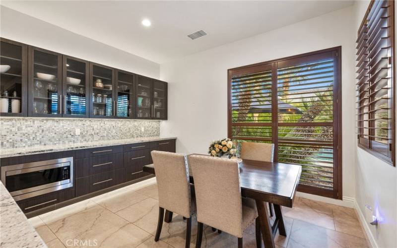 Kitchen eating area over looks backyard to the pool area.