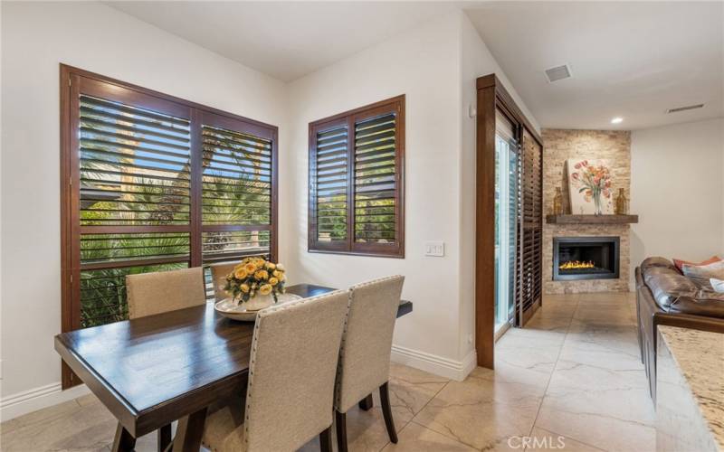 Kitchen eating area over looks backyard to the pool area.