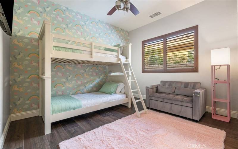 Guest bedroom 2 including bunkbed, small sofa and flatscreen TV.