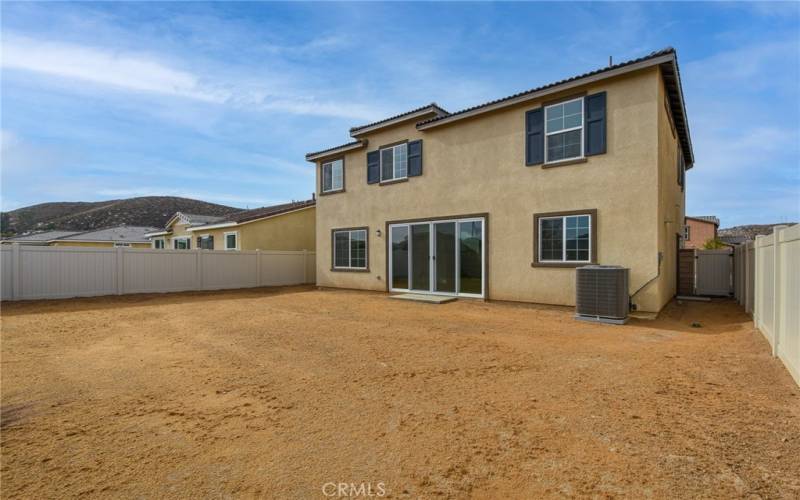 Backyard with vinyl fence and block wall