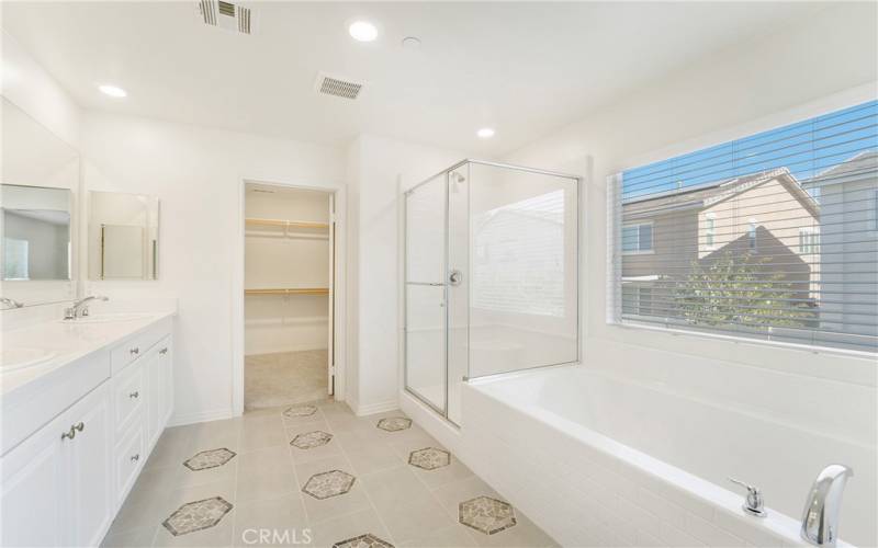 Primary bath features upgraded flooring, large soaking tub, separate shower, dual sinks, and separate toilet space w/ door. Light and bright!