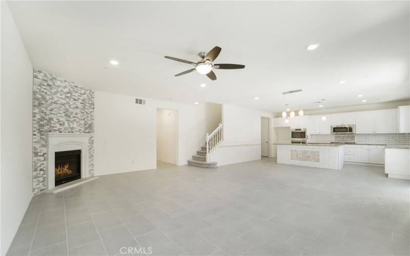 Custom tile work, a cozy fireplace, lots of light, modern, spacious great room.